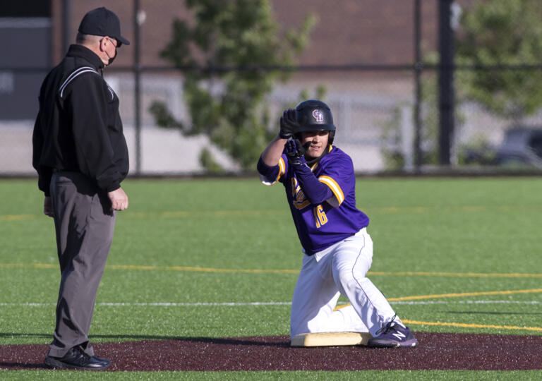 Columbia River’s Jordan Wiggins claps toward his team’s dugout after a double in a 2A Southwest District Tournament third-place game on Friday, May 7, 2021, at the Ridgefield Outdoor Recreation Complex. Columbia River won 3-2 over Washougal in eight innings.