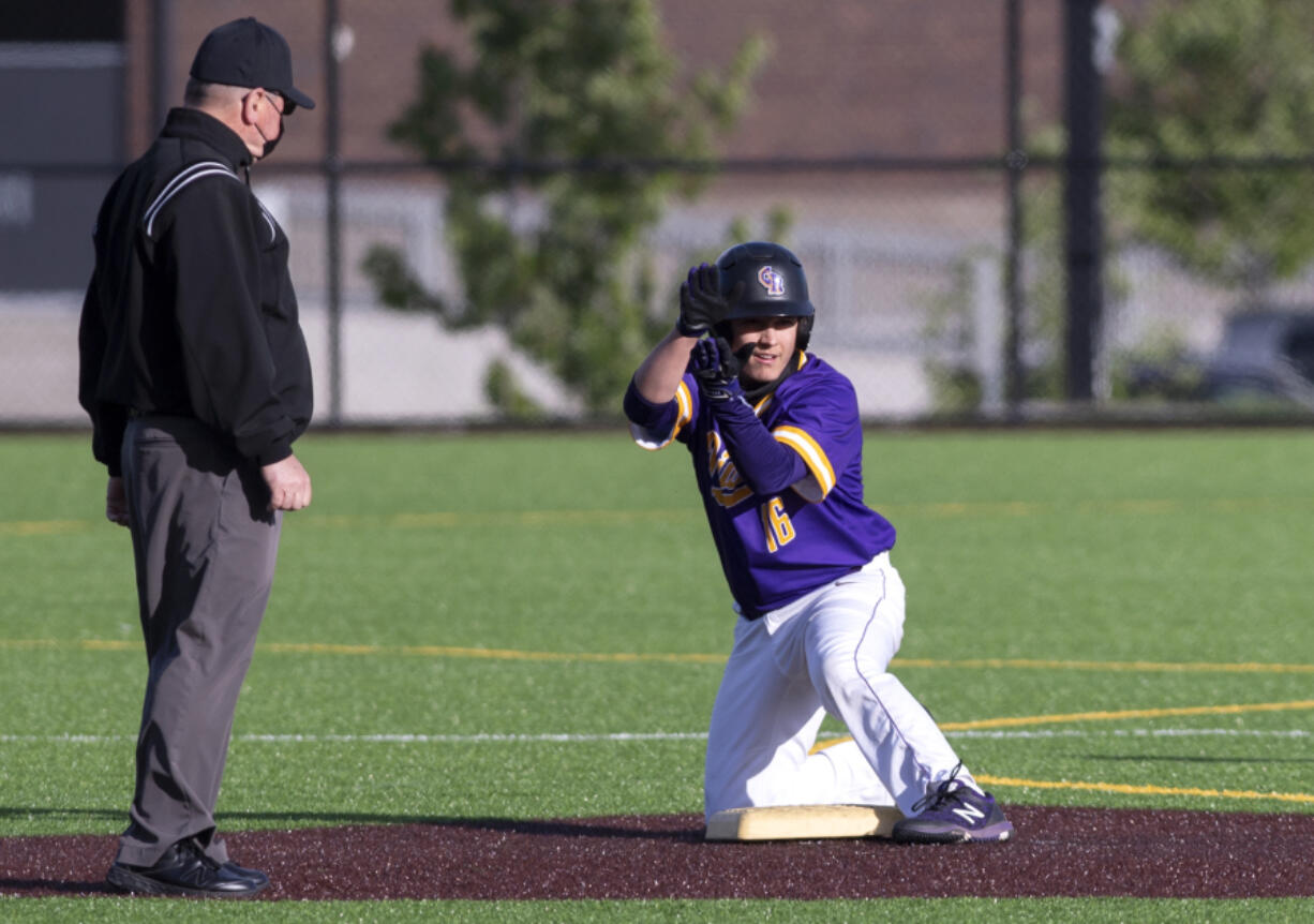 Columbia River's Jordan Wiggins claps toward his team'is dugout after a double in a 2A Southwest District Tournament third-place game on Friday, May 7, 2021, at the Ridgefield Outdoor Recreation Complex. Columbia River won 3-2 over Washougal in eight innings.