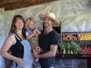 MacKenzie Krumhauer, 28, son, Oliver, 1 1/2 , and her husband, Sean, enjoy their new home at Thiselle Creek Farm in Yacolt. The family moved from Southern California in 2018 due to a wildfire destroying their previous land.  ""We can learn from other mistakes to make it so we're working in symbiosis with the environment rather than pushing back," MacKenzie said.