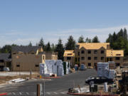 Stacks of lumber sit on the lot ready to be used to construct apartment buildings on Friday at the Latitude 45 apartment complex in Vancouver. Local builders have had to navigate rising lumber prices amid a national spike in demand.