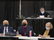 Plaintiffs Don Benton, foreground from left, Christopher Clifford and Susan Rice join Superior Court Judge Gregory Gonzales, background top, as they gather for closing arguments in their lawsuit against the county Monday afternoon at the Clark County Event Center at the Fairgrounds.