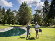 Golfers Cory Gerlack, left, and Geoffrey Howell wrap up a golf game at Lakeview Par 3 Golf Challenge.