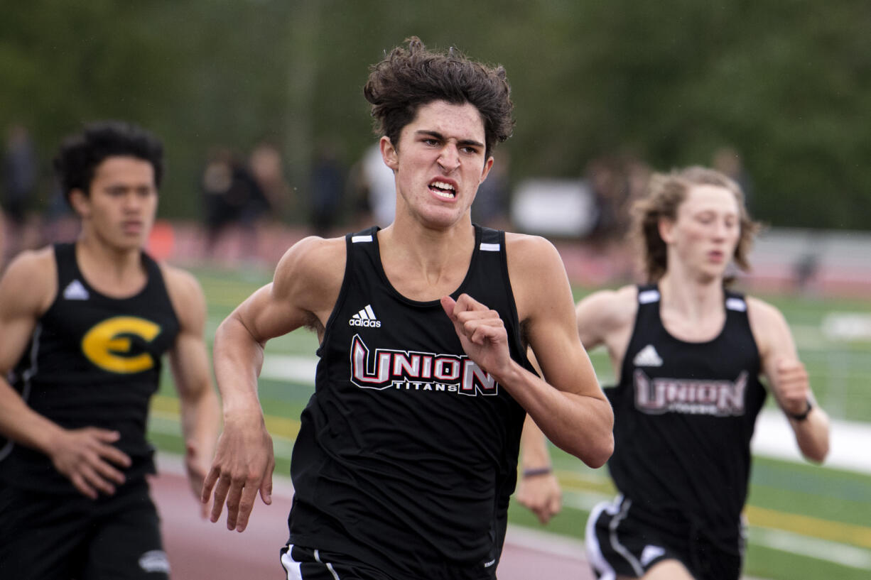 Union freshman Grayson Caldwell hustles his way down the back straight of the 400-meter race in a 4A/3A Greater St. Helens League dual on Tuesday, May 25, 2021, at Union High School. Caldwell finished second with a personal-best 52.82-second mark.