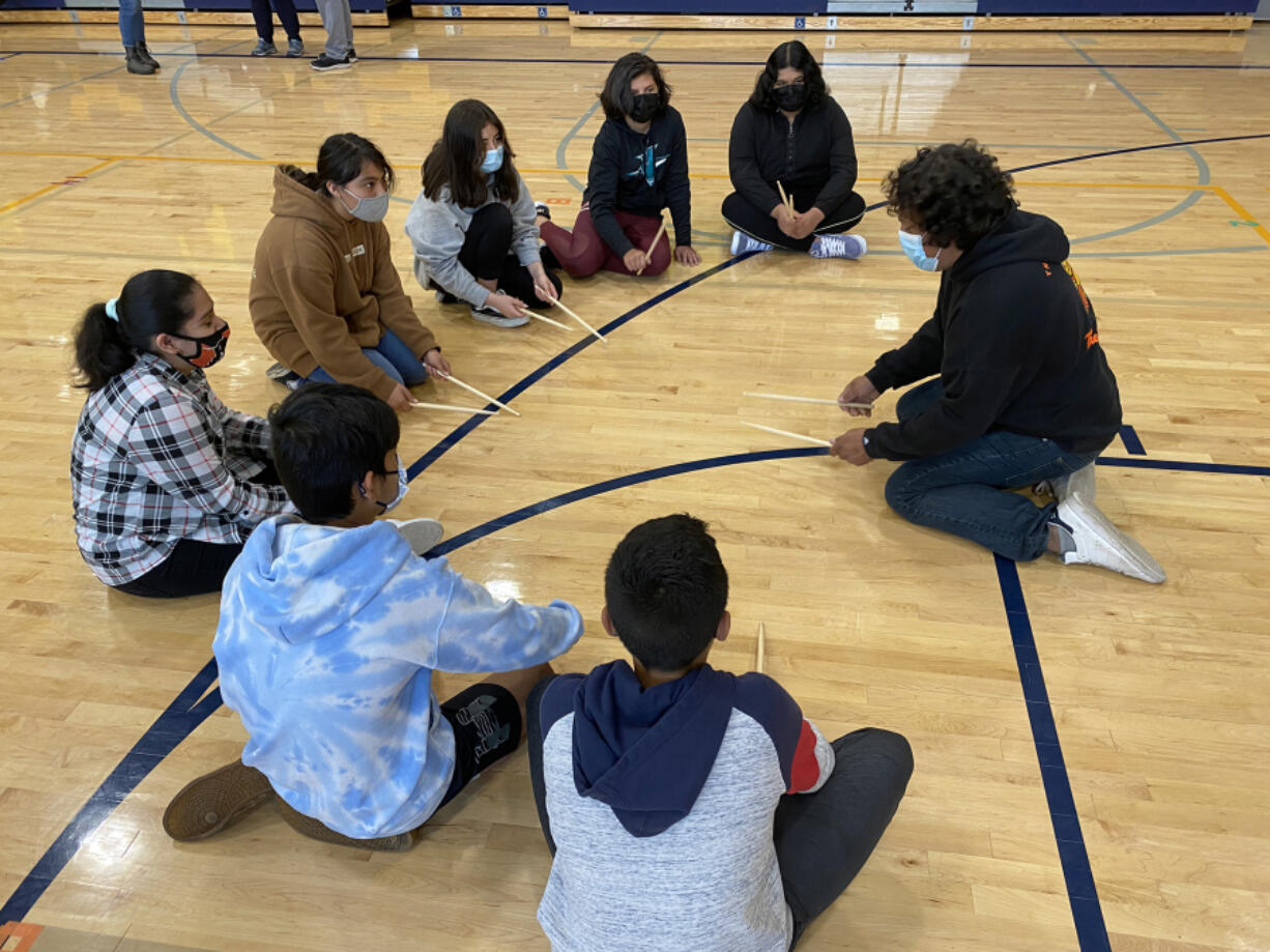 WASHOUGAL: Eddie Esparza, One of a Kind Drum Line, works with La Chispa participants at Jemtegaard Middle School.