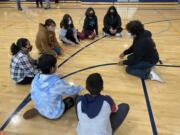 WASHOUGAL: Eddie Esparza, One of a Kind Drum Line, works with La Chispa participants at Jemtegaard Middle School.