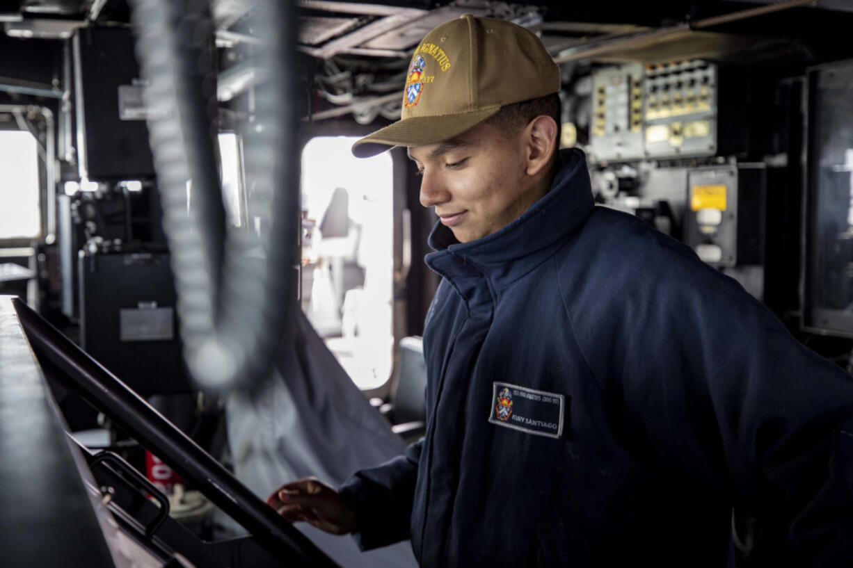 Seaman Kury Santiago, from Vancouver, mans the helm of the USS Paul Ignatius.