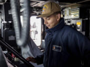 Seaman Kury Santiago, from Vancouver, mans the helm of the USS Paul Ignatius.