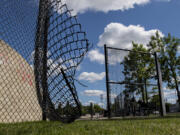 The fence surrounding the Battle Ground skate park sits ripped open at its northwest corner on Friday.