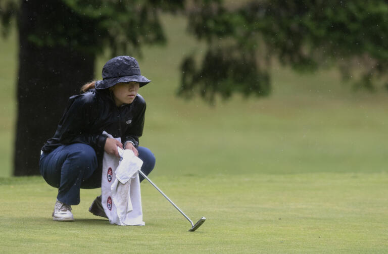 Union’s Jade Gruher reads a putt on the 11th hole in the 4A/3A district girls golf championships on Thursday, May 27, 2021, at Lewis River Golf Course in Woodland. Union sophomore Jade Gruher won the 4A title with a 76-77-185 total over two days. Kelso senior Liz Dolan scored a 74-80-186 to win the 3A title.