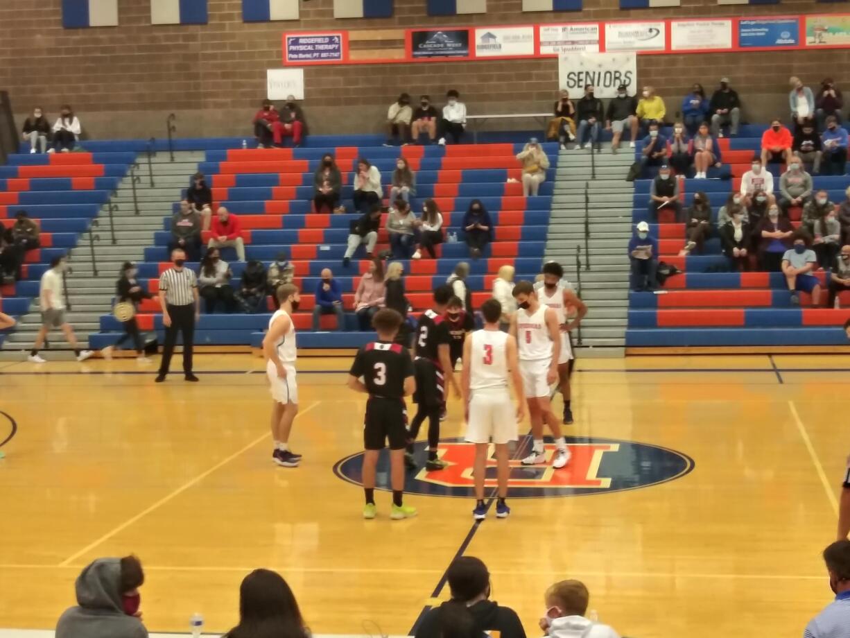 The Ridgefield and Fort Vancouver boys basketball teams get ready to tip off on Tuesday (Tim Martinez/The Columbian)