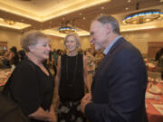 Vancouver resident Jane Jacobsen, from left, congratulates Michele and Greg Goodwin at an event at the Hilton Vancouver Washington in June 2017.