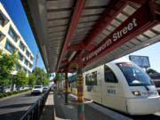 A northbound Yellow Line Max train, left, stops at the Killingsworth station in Portland, and an articulated hybrid bus, right, of the type used on C-Tran's bus rapid transit route, The Vine, is seen in Vancouver.  The question of whether TriMet's Yellow Line should be extended to Vancouver was a key point of contention during development of the Columbia River Crossing project and is often cited as one of the main disagreements that derailed the project. The current renewed replacement effort will consider both light rail and bus rapid transit options to meet the project's high-capacity transit needs, and no decision has been made yet - but recent comments from federal lawmakers pushed the still-simmering disagreement back into the spotlight.