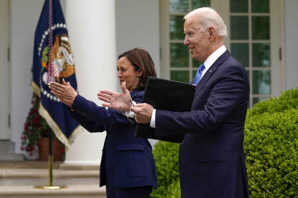 President Joe Biden claps with Vice President Kamala Harris after speaking on updated guidance on face mask mandates and COVID-19 response, in the Rose Garden of the White House, Thursday, May 13, 2021, in Washington.