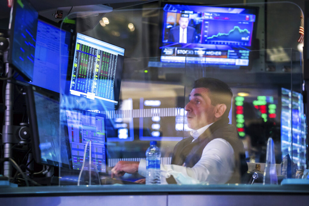 In this photo provided by the New York Stock Exchange, specialist Peter Mazza works at his post on the floor of the New York Stock Exchange, Tuesday, May 18, 2021. Stocks were mixed, moving between small gains and losses on Tuesday morning, as investors remain focused on the possibility for more inflation later this year as well as the economic recovery as the coronavirus pandemic comes to a close.