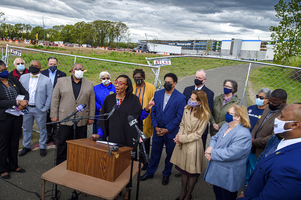 Windsor Town Council member Nuchette Black-Burke, center, with state and local elected leaders together with the CT NAACP, speaks out at news conference May 7, 2021, in Windsor, Conn.,  after a noose was found at an Amazon warehouse construction site, rear,. Amazon has temporarily shut down a new warehouse construction site in Connecticut after a seventh noose was found Wednesday, May 19, 2021, hanging over a beam, a series of incidents local police called “potential” hate crimes.