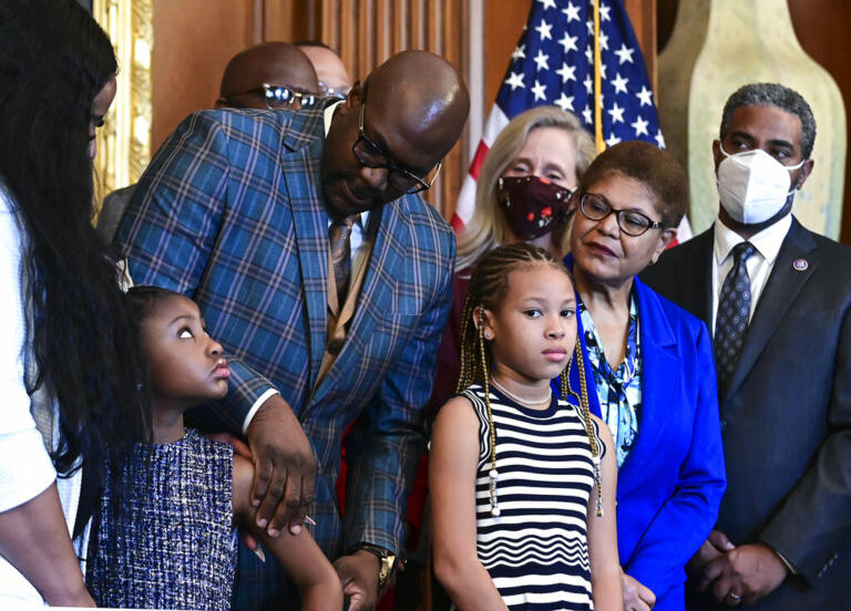 Philonise Floyd, George Floyd's brother, looks down at Gianna Floyd, George Floyd's daughter, while while standing with members of the Floyd family prior to a meeting to mark the anniversary of the death of George Floyd with House Speaker Nancy Pelosi, D-Calif., Tuesday, May 25, 2021 at the Capitol in Washington.