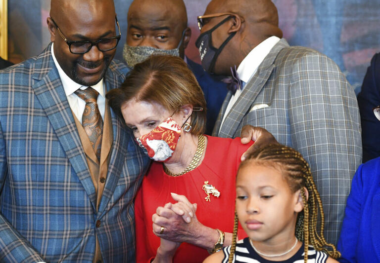 Philonise Floyd, the brother of George Floyd, puts his arms around House Speaker Nancy Pelosi of Calif., as he and other members of the Floyd family meet with members of congress in the Rayburn Room of the U.S.