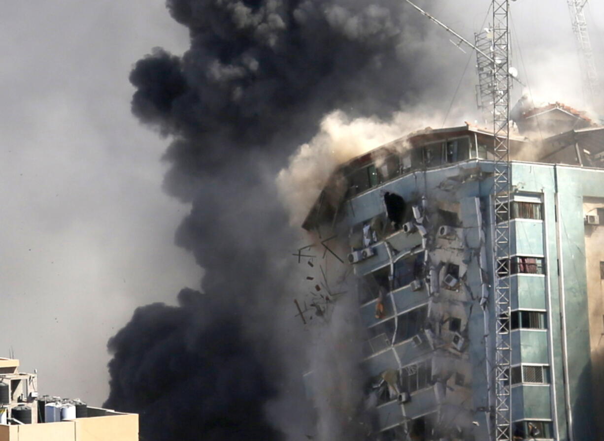 The building housing the offices of The Associated Press and other media in Gaza City collapses after it was hit by an Israeli airstrike Saturday, May 15, 2021. The attack came roughly an hour after the Israeli military warned people to evacuate the building, which also housed Al-Jazeera and a number of offices and apartments. There was no immediate explanation for why the building was targeted.