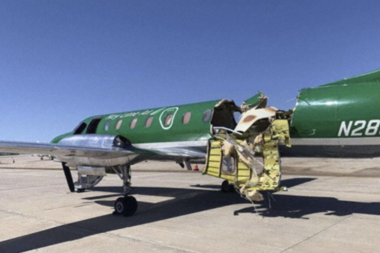 This image from CBS Denver shows a Key Lime Air Metroliner that landed safely at Centennial Airport after a mid-air collision near Denver on Wednesday, May 12, 2021. Federal officials say two airplanes collided but that there are no injuries. The collision between a twin-engine Fairchild Metroliner and a single-engine Cirrus SR22 happened as both planes were landing, according to the National Transportation Safety Board. Key Lime Air, which owns the Metroliner, says its aircraft sustained substantial damage to the tail section but that the pilot was able to land safely.