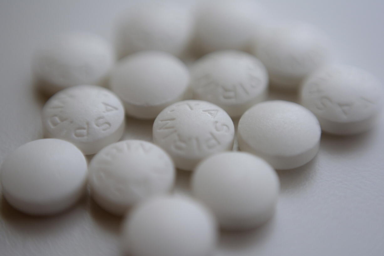 FILE - This Aug. 23, 2018 file photo shows an arrangement of aspirin pills in New York. A large study finds that low-dose and regular-strength aspirin seem equally safe and effective for preventing additional heart problems in people who already have heart disease.