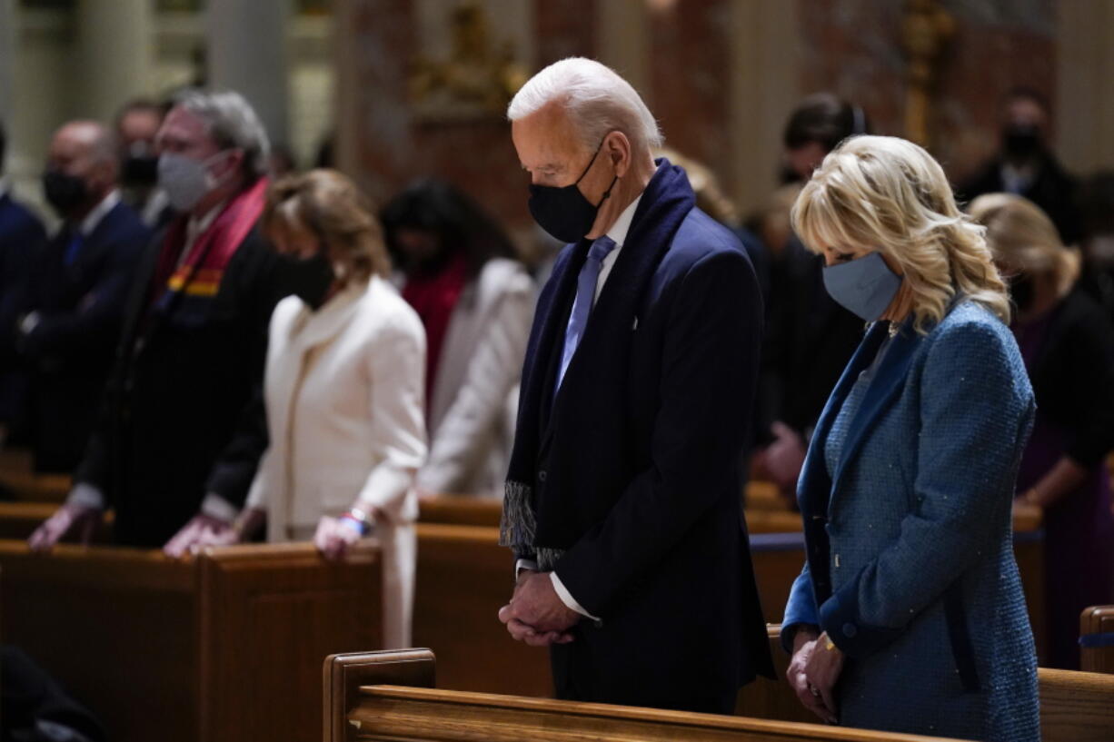 FILE - In this Wednesday, Jan. 20, 2021 file photo, President-elect Joe Biden and his wife, Jill Biden, attend Mass at the Cathedral of St. Matthew the Apostle during Inauguration Day ceremonies in Washington. When U.S. Catholic bishops hold their next national meeting in June 2021, they'll be deciding whether to send a tougher-than-ever message to President Joe Biden and other Catholic politicians: Don't partake of Communion if you persist in public advocacy of abortion rights.