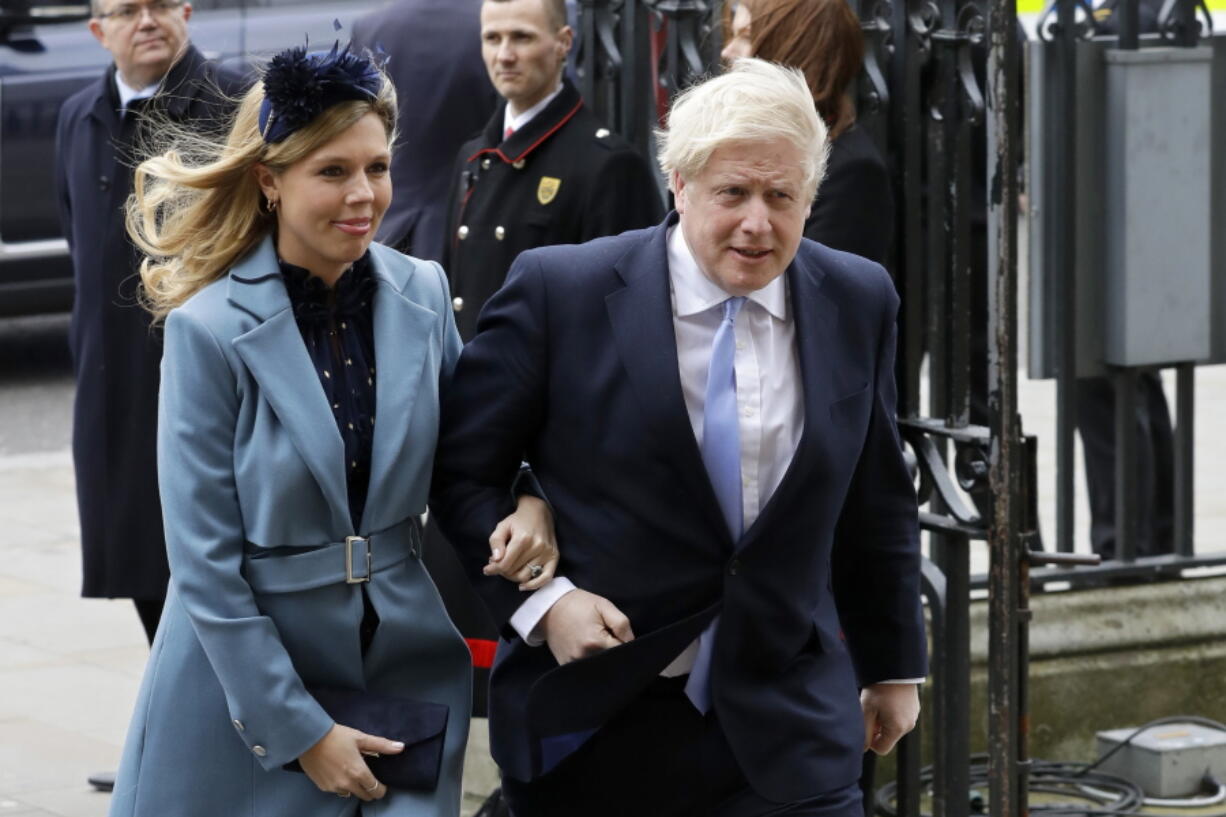 FILE - In this Monday, March 9, 2020, file photo Britain's Prime Minister Boris Johnson and his partner Carrie Symonds arrive to attend the annual Commonwealth Day service at Westminster Abbey in London. U.K. newspapers are reporting that Prime Minister Johnson and his fianc?e Symonds married Saturday, May 29, 2021, in a small private ceremony in London. The Mail on Sunday and the Sun said the couple wed at the Roman Catholic Westminster Cathedral in front of a small group of friends and family.