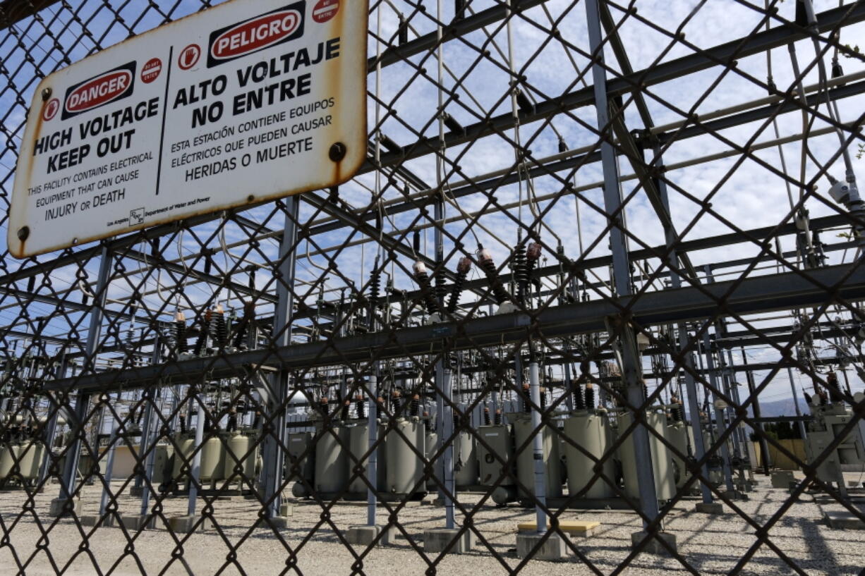 FILE - In this Aug. 15, 2020, file photo, high voltage signs are posted on the Department of Water and Power Sub Station E in the North Hollywood section of Los Angeles. Last summer, an extreme heat wave across the United States increased demand for electricity so much that state officials had to briefly turn off the power for hundreds of thousands of people. On Tuesday, May 18, 2021, the state's top energy regulators told state lawmakers they are better prepared for a similar scenario this year. But they said they could not guarantee rolling blackouts would not happen again.