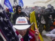 FILE - In this Jan. 6, 2021, file photo, rioters try to break through a police barrier, at the Capitol in Washington.