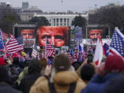 FILE - In this Jan. 6, 2021 file photo, Trump supporters participate in a rally in Washington. Many of those who stormed the Capitol on Jan. 6 cited falsehoods about the election, and now some of them are hoping their gullibility helps them in court. Attorneys for several defendants facing charges connected to the deadly insurrection say they will raise their client's belief in conspiracy theories and misinformation, either as an explanation for why they did what they did, or as an attempt to create a little sympathy.