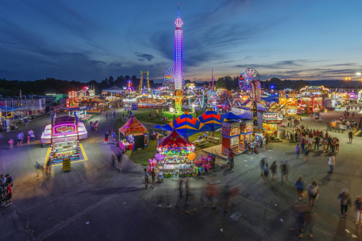 FILE - In this Aug. 9, 2018, file photo, fair-goers attend The State Fair of West Virginia at the State Fairgrounds in Fairlea, W.Va. West Virginia has seen a higher percentage of residents depart than any other state in the past decade.