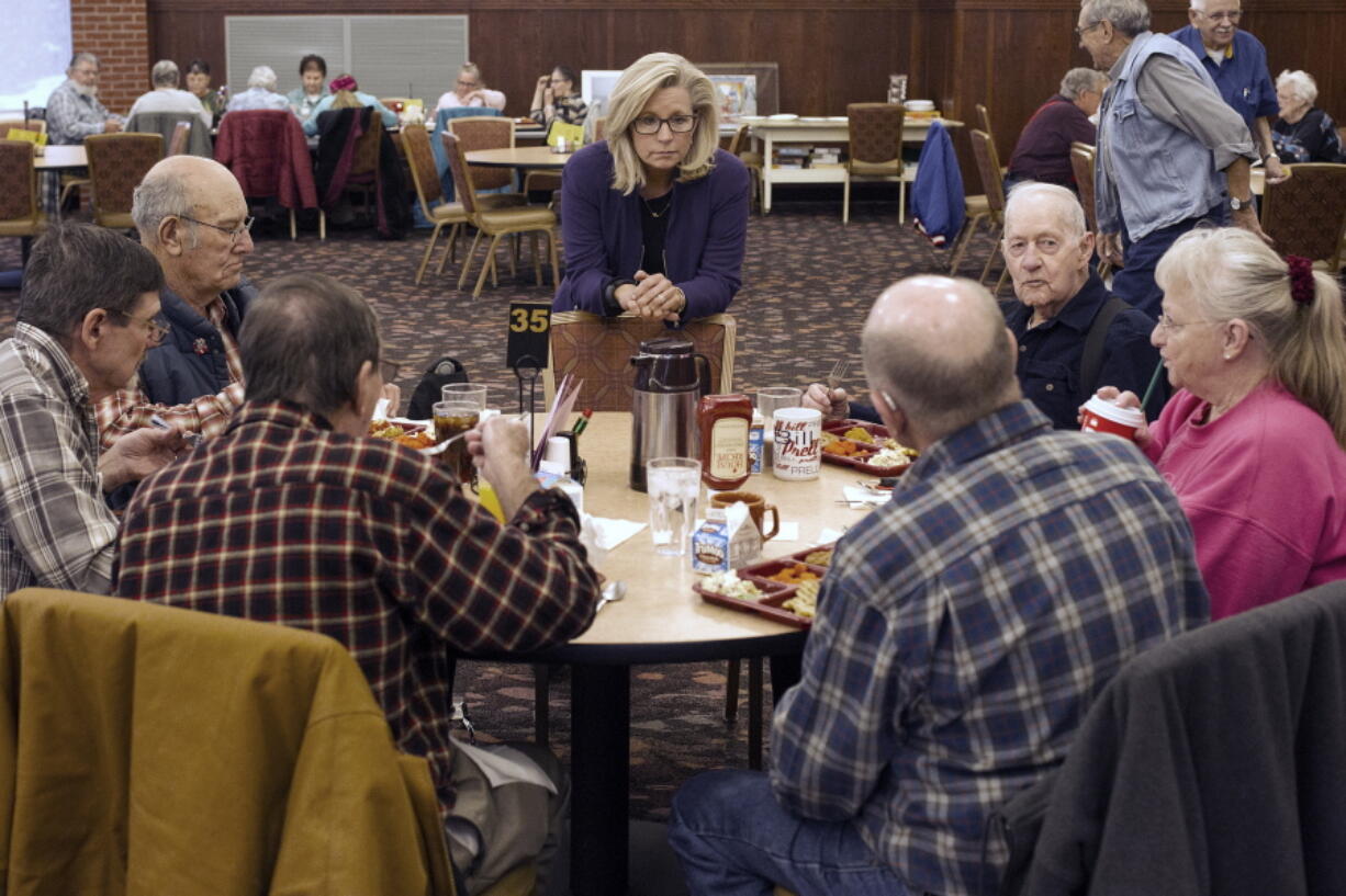 FILE - In this Feb. 1, 2016, file photo, Liz Cheney, center, talks to people at the Senior Citizens Center in Gillette, Wyo., after earlier in the day announcing she would run fro Congress. Removing congresswoman Liz Cheney from House GOP leadership was a relatively easy task for pro-Trump Republicans compared to their growing effort to boot her from office.