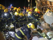 In this photo released by China's Xinhua News Agency, emergency personnel search through the wreckage of buildings destroyed by a reported tornado in Wuhan in central China's Hubei Province, early Saturday, May 15, 2021. Two tornadoes killed several people in central and eastern China and left hundreds of others injured, officials and state media reported Saturday.