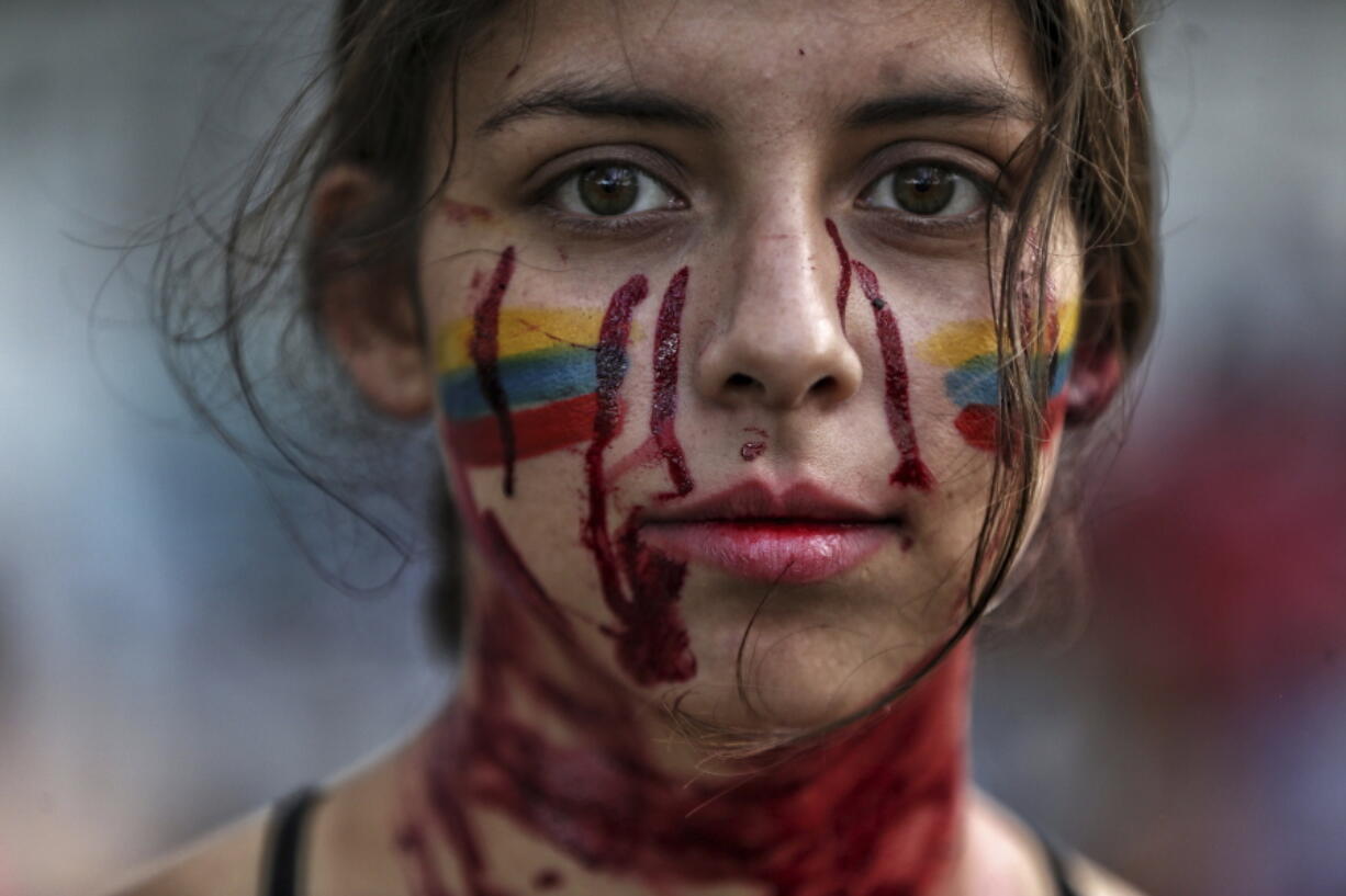 A student performs a play called "Who killed them" during anti-government protests in Cali, Colombia, Tuesday, May 11, 2021. Colombians have protested across the country against a government they feel has long ignored their needs, allowed corruption to run rampant and is so out of touch that it proposed tax increases during the coronavirus pandemic.