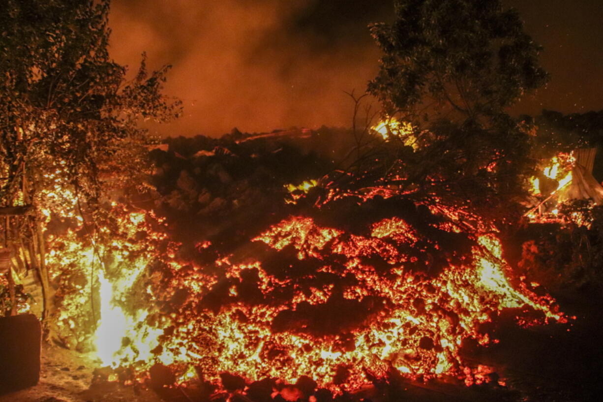 Lava from the eruption of Mount Nyiragongo is seen in Buhene, on the outskirts of Goma, Congo in the early hours of Sunday, May 23, 2021. Congo's Mount Nyiragongo erupted for the first time in nearly two decades Saturday, turning the night sky a fiery red and sending lava onto a major highway as panicked residents tried to flee Goma, a city of nearly 2 million.