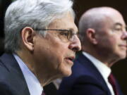 Attorney General Merrick Garland, left, and Homeland Security Secretary Alejandro Mayorkas, testify before the Senate Appropriations committee hearing to examine domestic extremism, Wednesday, May 12, 2021 on Capitol Hill in Washington.