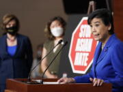 Rep. Judy Chu, D-Calif., right, speaks during a news conference on Capitol Hill in Washington, Tuesday, May 18, 2021, on the COVID-19 Hate Crimes Act as House Speaker Nancy Pelosi of Calif., left, and Rep. Grace Meng, D-N.Y., center, listen.