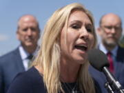 Rep. Marjorie Taylor Greene, R-Ga., speaks during a news conference, Wednesday, May 12, 2021, with Rep. Dan Bishop, R-N.C., back left, and former OMB Director and President of Citizens for Renewing America Russ Vought, as they express their opposition to "critical race theory," during a news conference on Capitol Hill in Washington.