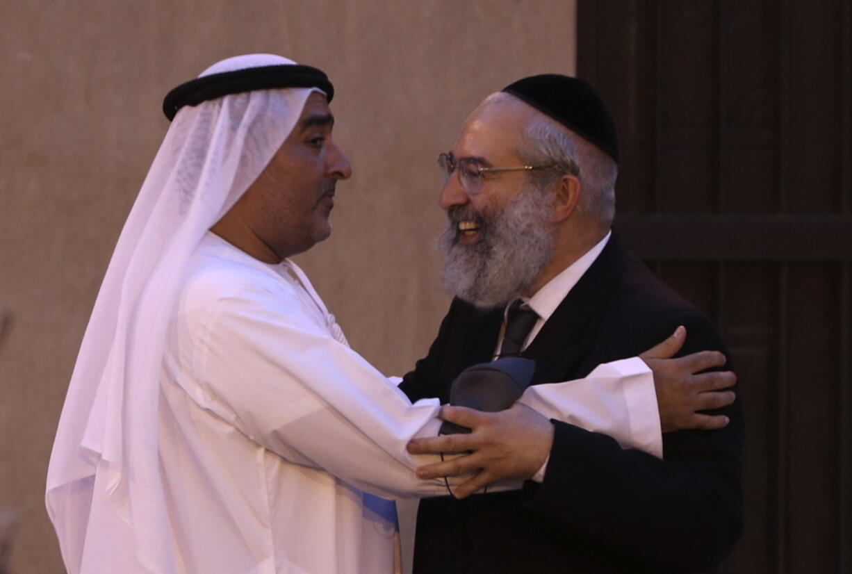 Ahmed Al Mansuri, founder of Crossroads of Civilization private museum, left, greets a rabbi at an exhibition commemorating the Jewish Holocaust in Dubai, United Arab Emirates, Wednesday, May 26, 2021. Israel's top diplomat to the United Arab Emirates attended a ceremony in Dubai on the grounds of the Arabian Peninsula's first permanent exhibition to commemorate the Holocaust. Hours earlier, he'd attended an event establishing a joint venture between an Israeli and Emirati company.