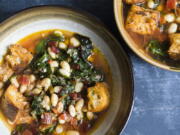 This image released by Milk Street shows a recipe for Tuscan Soup. Milk Street kitchens start from scratch with ciabatta croutons and canned white beans. Sturdy greens such as red-veined Swiss chard add color and texture from crispy stems. They are saut'eed with onions and bell pepper. If you like, serve the soup topped with grated Parmesan cheese.