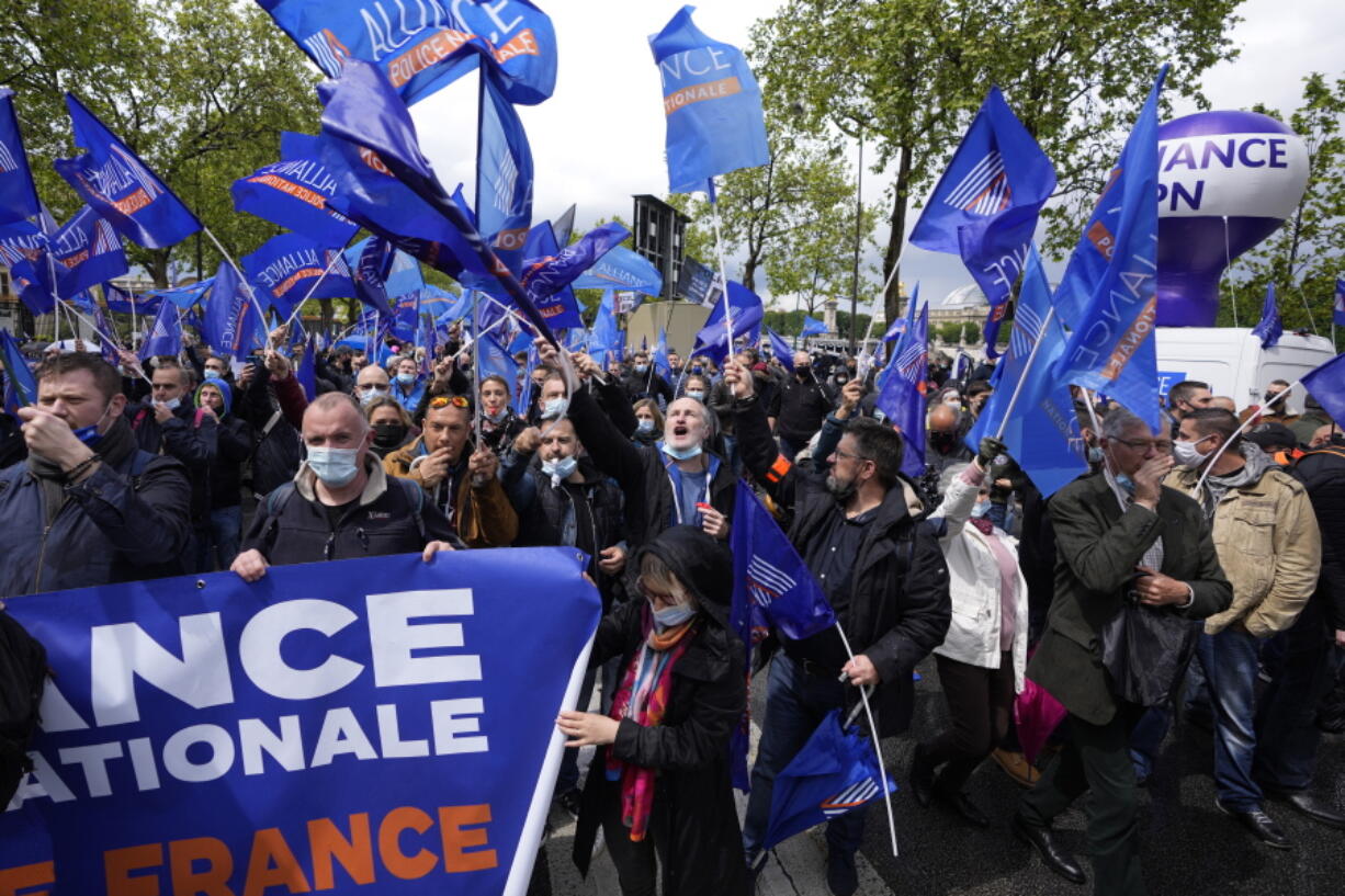 Police officers demonstrate Wednesday, May 19, 2021 in Paris. French police, feeling angry, vulnerable to attacks and useless, are holding an unusual demonstration Wednesday outside parliament to press for a law that protects the protectors.