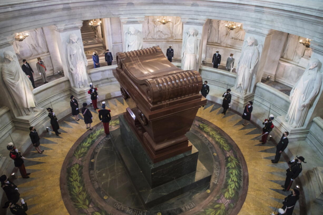 French President Emmanuel Macron and his wife Brigitte Macron, top, stand by the tomb of Napoleon Bonaparte during a ceremony to commemorate the 200th anniversary of Napoleon Bonaparte's death, at the Invalides monument in Paris, Wednesday, May 5, 2021.