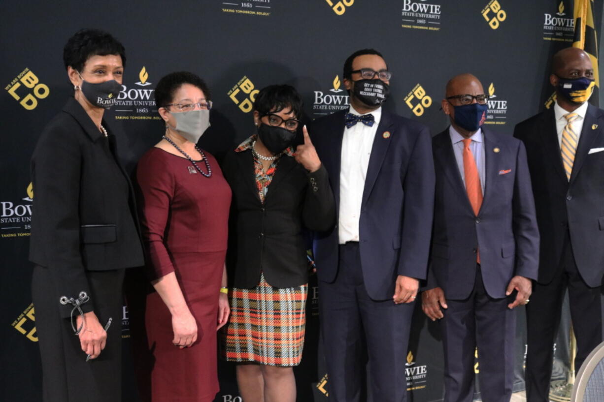 FILE - In this March 24, 2021 file photo, Maryland House Speaker Adrienne Jones, third from left, points up while standing with the presidents of Maryland's four historically Black colleges and Universities after a bill signing ceremony in Bowie, Md., to set aside $577 million to settle a federal lawsuit. From left are, Aminta Breaux, president of Bowie State University, Heidi Anderson, president of the University of Maryland Eastern Shore, Jones, Sen. Charles Sydnor, David Wilson, president of Morgan State University, and Anthony Jenkins, president of Coppin State University. Maryland officials announced Wednesday, April 28 they have finalized the settlement with attorneys to end the 15-year-old federal lawsuit relating to underfunding at the state's four historically Black colleges and universities.