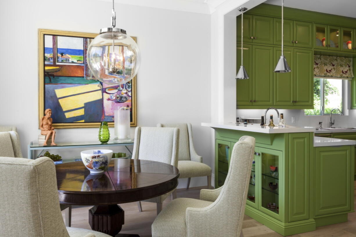 This image provided by Tom Stringer Design Partners shows a kitchen and dining room. Color is a simple way to create an upbeat feel, says John Cialone of Tom Stringer Design Partners in Chicago. The firm recently completed a Palm Springs, California, project where they brought in a vibrant kiwi green.