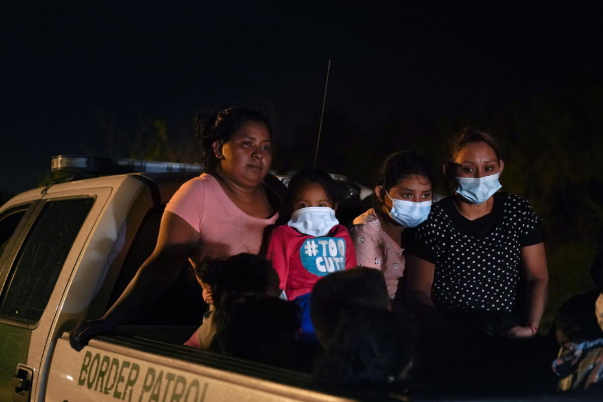 Migrants from Honduras wait in a Border Patrol truck after turning themselves in upon crossing the U.S.-Mexico border Monday, May 17, 2021, in La Joya, Texas. The Biden administration has agreed to let up to about 250 people a day in the United States at border crossings with Mexico to seek refuge, part of negotiations to settle a lawsuit over pandemic-related powers that deny migrants a right to apply for asylum, an attorney said Monday.