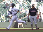 Seattle Mariners' Mitch Haniger runs past Cleveland Indians first baseman Josh Naylor following a solo home run during the first inning of a baseball game Saturday, May 15, 2021, in Seattle.