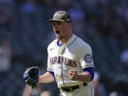 Seattle Mariners relief pitcher Anthony Misiewicz lets out a yell and pumps a fist after a double play with bases loaded ended the top of the seventh inning of a baseball game against the Cleveland Indians Sunday, May 16, 2021, in Seattle.