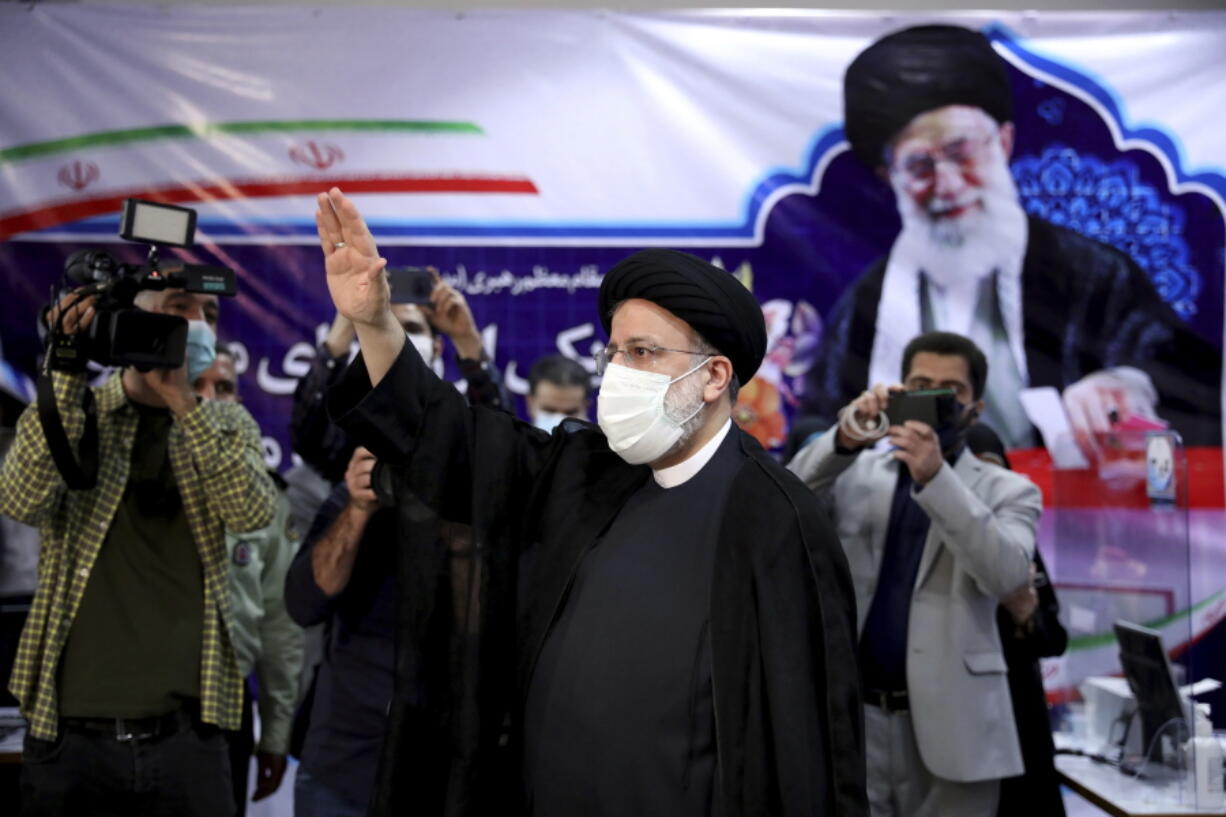 Ebrahim Raisi, head of Iran's judiciary waves to media as he attends at the Interior Ministry to register his candidacy for the June 18 presidential elections at the elections headquarters of the Interior Ministry in Tehran, Iran, Saturday, May 15, 2021.