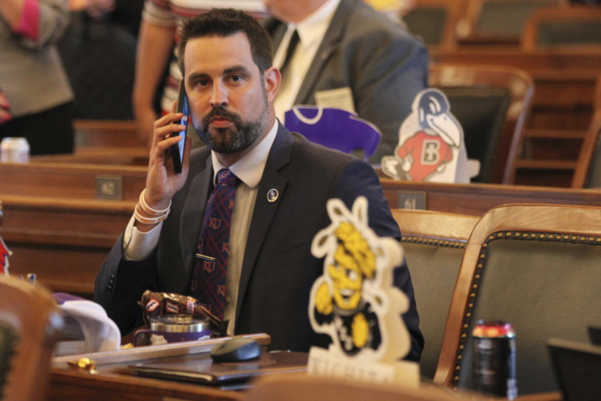 In this photo from Monday, May 3, 2021, Kansas state Rep. Mark Samsel, R-Wellsville, talks on his cellphone ahead of the House's daily session, at the Statehouse in Topeka, Kan. Samsel has been charged with three counts of misdemeanor battery over incidents involving two teenage students while he was substitute teaching.