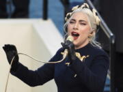 FILE - In this Jan. 20, 2021 file photo, Lady Gaga sings the national anthem during President-elect Joe Biden's inauguration at the U.S. Capitol in Washington. Los Angeles Police Department (LAPD) served several search and arrest warrants as a result of the investigation in the robbery of Lady Gaga's two stolen French bulldogs and shooting of her dog walker, Ryan Fischer, authorities announced Thursday, April 29, 2021, in Los Angeles.