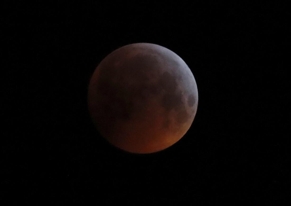 The Earth's shadow falls across the full moon Jan. 21, 2019, seen above Brighton, southeast England. The first total lunar eclipse in more than two years coincides with a supermoon this week for a cosmic show.